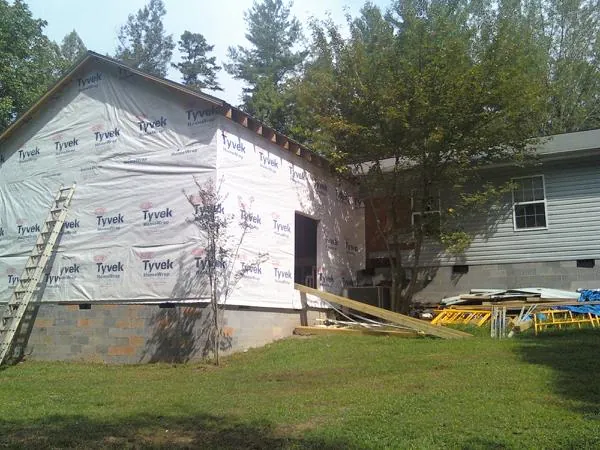 Tyvek wrapped gable on a new room addition beside an existing home in Lockport